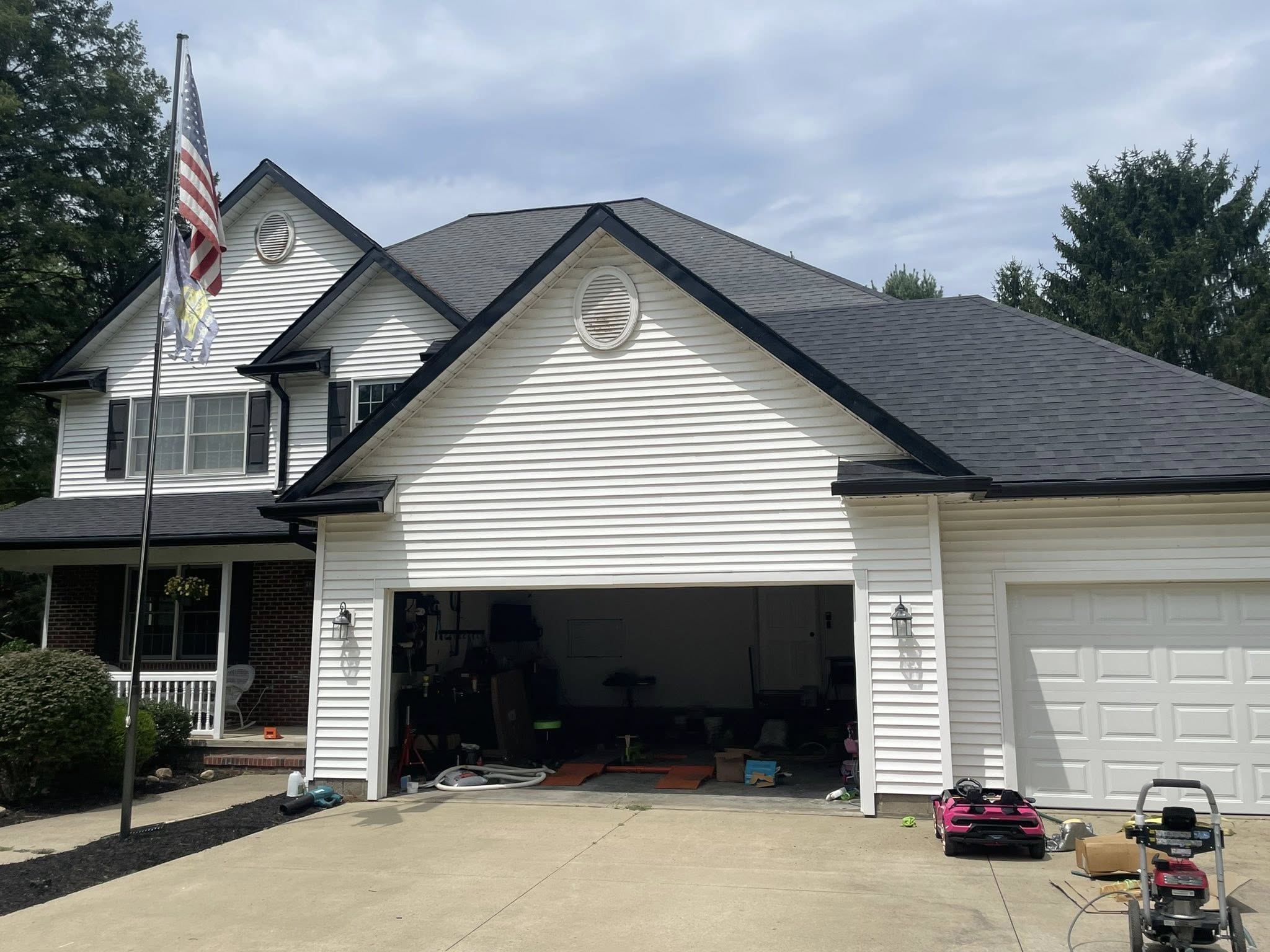 New seamless black aluminum gutters installed on a Northeast Ohio home